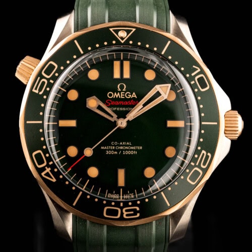 2025 Omega Seamaster Diver 300M ref. 210.92.42.20.10.001 in titanium and bronze gold with a green dial on a green rubber strap.