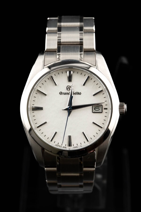 2025-grand-seiko-quartz 2025 Grand Seiko 9F62 quartz with textured white dial and blue seconds hand on steel bracelet
