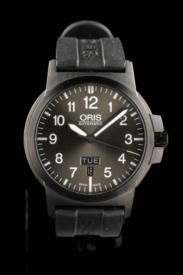t Oris BC3 Advanced Day Date in dark PVD steel with grey sunburst dial and day-date window on black rubber strap