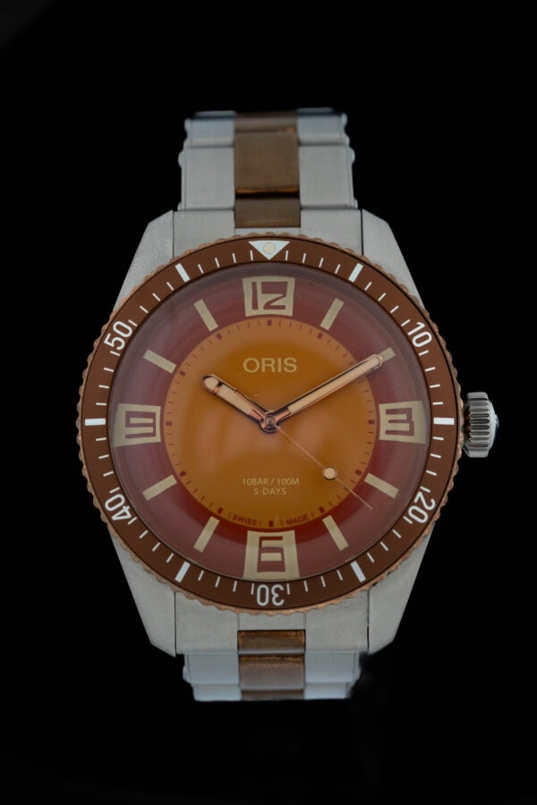 2023 Oris Divers Seventy-Five Calibre 400 Collective Horology with orange dial and brown bezel on two-tone bracelet