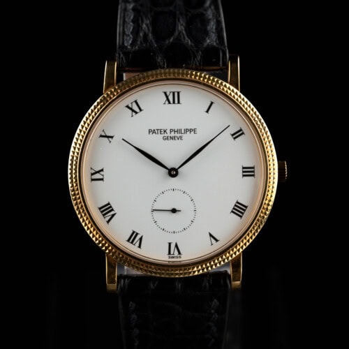 1993 Patek Philippe Calatrava 3919 in 18k yellow gold with white Roman dial and hobnail bezel on black leather strap